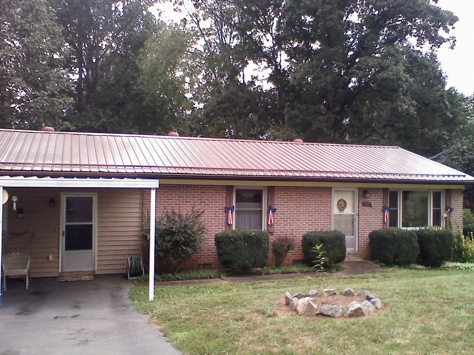 Bronze metal roof and carport on a brick ranch home — Roof Repair work by our crew in Pacific